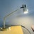 Vintage 1980s articulated desk lamp made in Portugal, featuring a sleek chromed metal structure with elegant gold-tone...