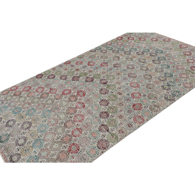 Handknotted in wool, this 5x8 vintage rug originates from Turkey, circa 1960-1970 and is believed to hail from the Turkish...
