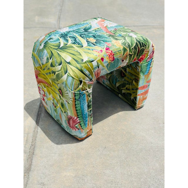 A striking vintage waterfall bench newly upholstered in luxurious designer velvet featuring a vibrant tropical botanical...