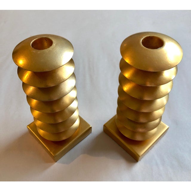 Elegant gold gilt design metal candleholders, circa 1980, France. Signed Illegibly on bottom felt. It appears to be...