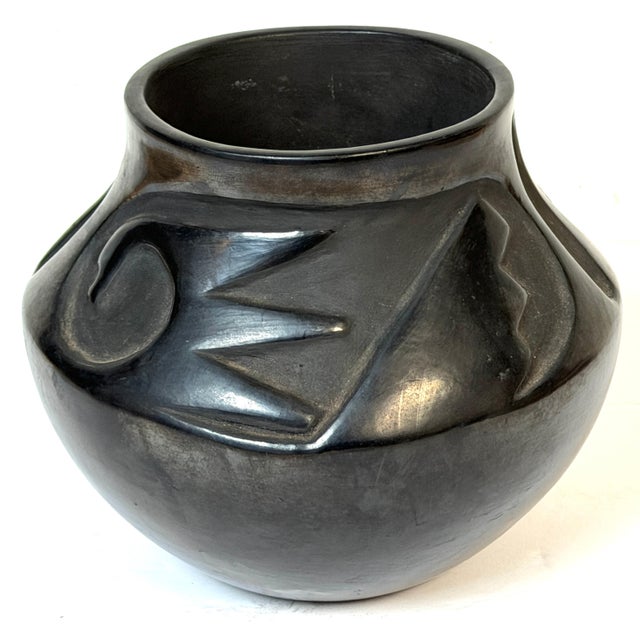 Signed Santa Clara Pueblo Carved Blackware Pottery Vase, Juanita Pueblo, Mid-20th Century This sculptural blackware...
