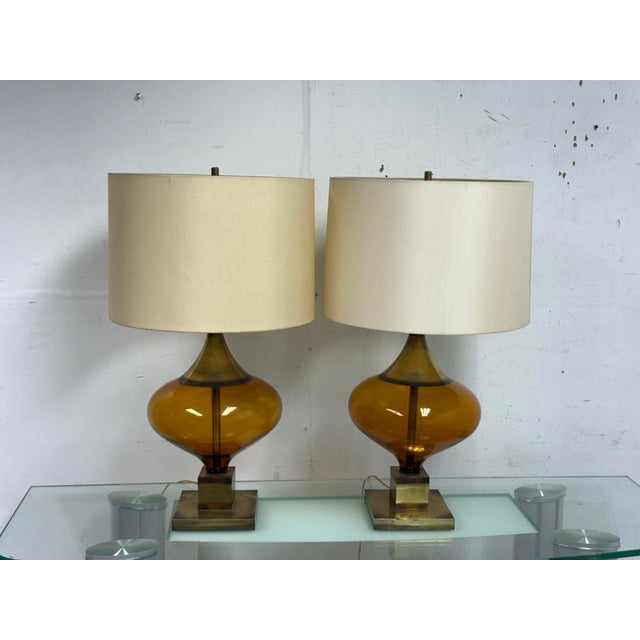 Design Plus Gallery presents a Pair of Amber Glass Table Lamps from the Mid 20th Century. The style has a look and feel of...