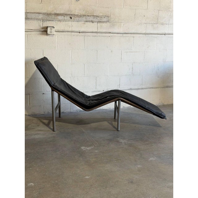 This vintage chaise lounge chair features an ergonomically contoured silhouette designed for relaxed reclined seating....