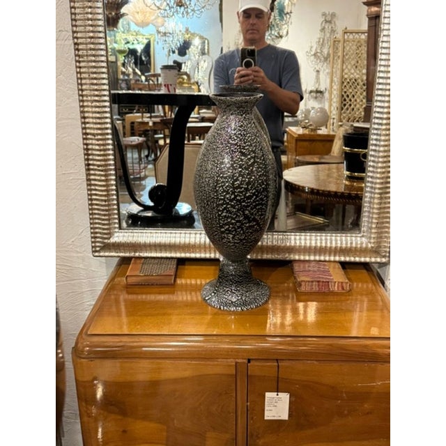 The Black Murano Glass Vase is a striking decorative piece that would be beautiful in any home. The unique craftsmanship...