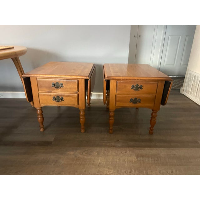 Beautifully crafted Ethan Allen Heirloom drop-leaf end tables in nutmeg maple finish. Early American colonial style with...