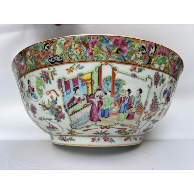 A single large Chinese export porcelain punch bowl featuring traditional rose medallion style decoration including...