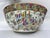 A single large Chinese export porcelain punch bowl featuring traditional rose medallion style decoration including...