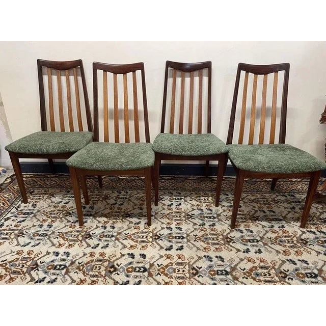 Stylish set of four original G-Plan dining chairs with beautifully shaped teak frames and elegant slatted backs. The...