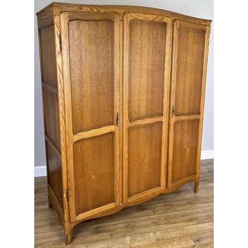 This elegant Vintage French Louis wardrobe presents classic styling with a warm oak finish, graceful lines, and refined...
