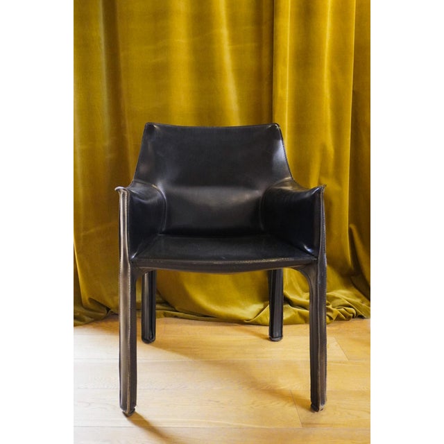 Cab 413 armchair in black leather by Mario Bellini for Cassina. The Cab armchair consists of a tubular frame over which a...