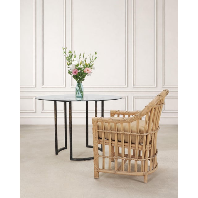 A refined modern round glass and bronze pedestal table, designed by Thomas Pheasant for McGuire, San Francisco. The...