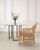 A refined modern round glass and bronze pedestal table, designed by Thomas Pheasant for McGuire, San Francisco. The...