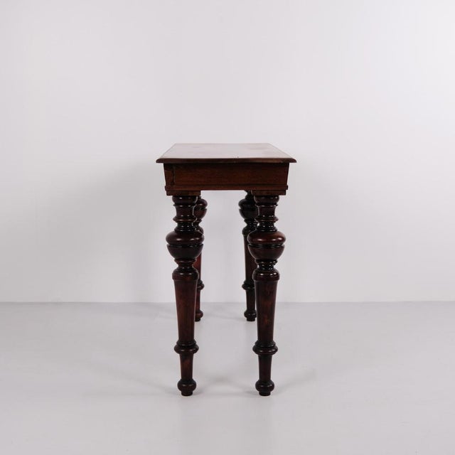 Wall table also used as a console table made in mahogany from around the 1880s. The table features round carved legs and...