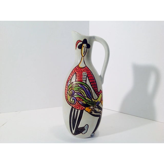 Carl-Harry Stålhane for Rörstrand / Rørstrand. Vase with handle in glazed ceramics. Hand painted lady holding a basket of...