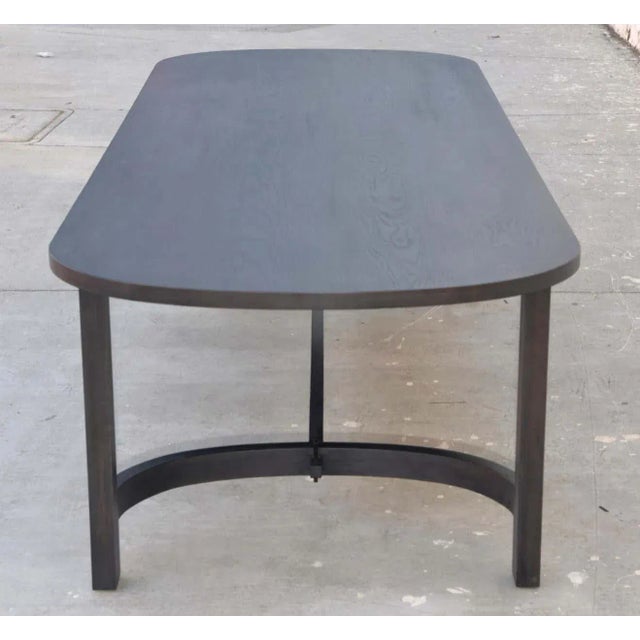This ebonized racetrack table, designed in collaboration with Jake Alexander Arnold, is seen here in 120" x 42" We use...
