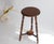 An antique stool made out of oak with carved bobbin legs. The stool is made in England and is round in shape standing on...