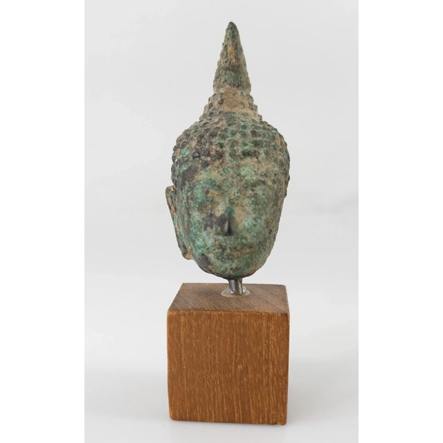 We are selling this early South East Asian bronze buddha head. This typical Thai Sukhothai budda head has simple form with...