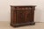 An Italian beautifully-carved walnut cabinet from the early 19th century, possibly older. This antique walnut buffet from...