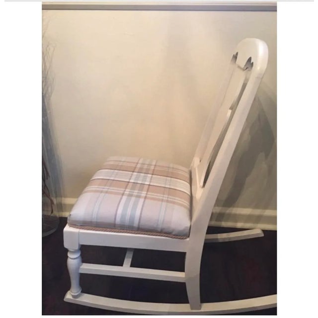 This vintage children's rocker has been painted in ivory has a clear wax sealer and has a dusting of gold gilding wax. The...