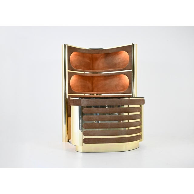 The set includes a three-shelf unit with illuminated shelves in suede and gold-tone metal. It also includes a counter in...