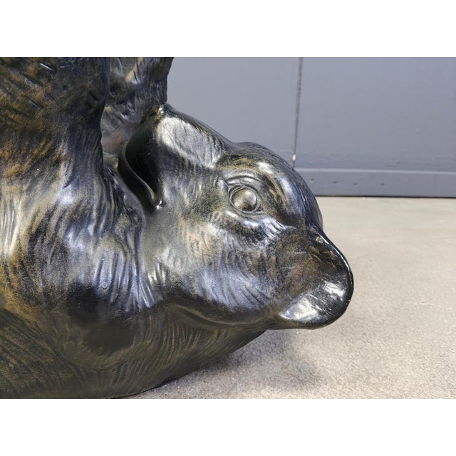 Eye-catching sculptural black bear coffee table. This unique table looks great and somewhat cute. Base is made of plaster....