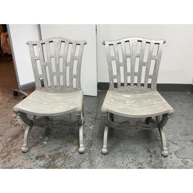 Design Plus Gallery presents a pair of Regency Reproduction Side Chairs. The gray painted wood displays a distressed...