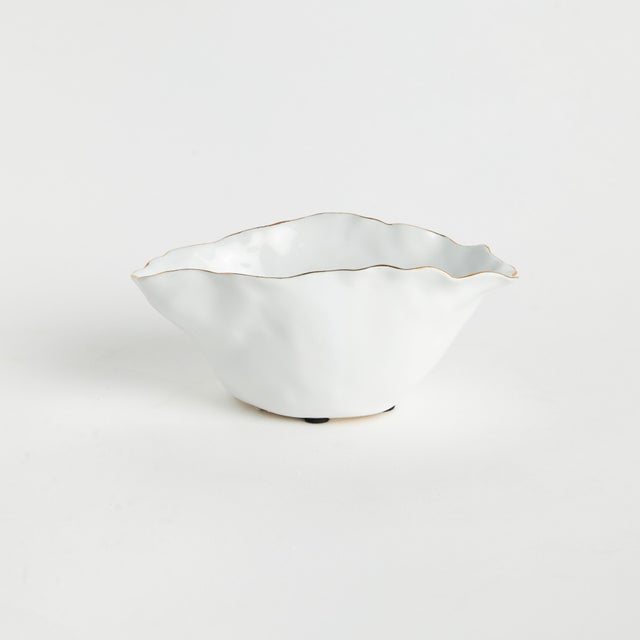 With crimped edges and natural form, this wide vase is a real statementmaking centerpiece. The handbrushedGold tipped...