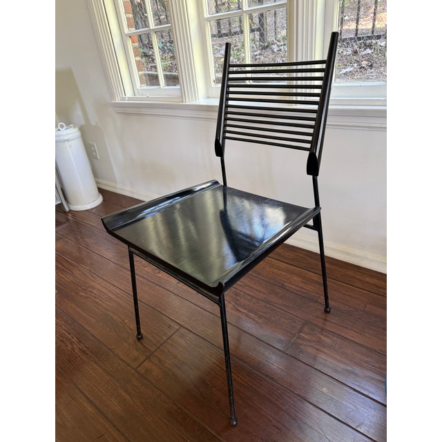 Paul McCobb “Shovel” chair with a painted wood seat and slatted back on an iron frame. Clean lines and a simple,...