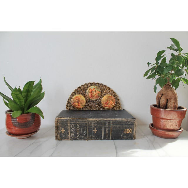 Vintage gold plated wall art hand fan Victorian porcelain cameos. The cameos are not hand painted. Ready to hang. Minor...