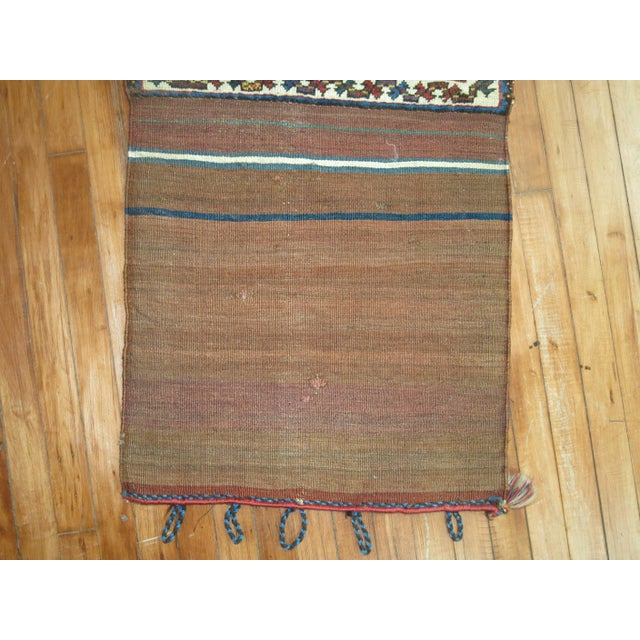 A tribal Bagface rug from the 19th century. The weaver intentionally added Kilim in one end giving it a unique feel....