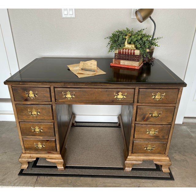 The Vintage Drexel American Traditional Desk features an antique brass handle finish, brown stained pine highlighting the...