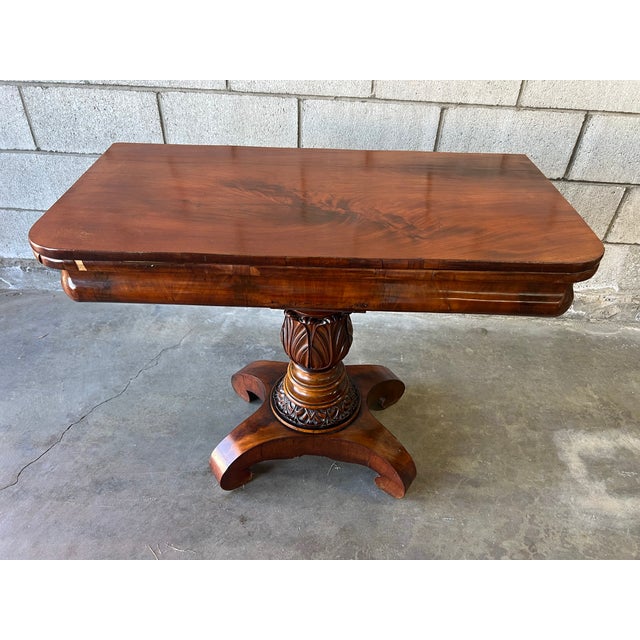 Exceptional 19th-century American Empire folding game table, circa 1840–1860, crafted in richly figured mahogany. The...