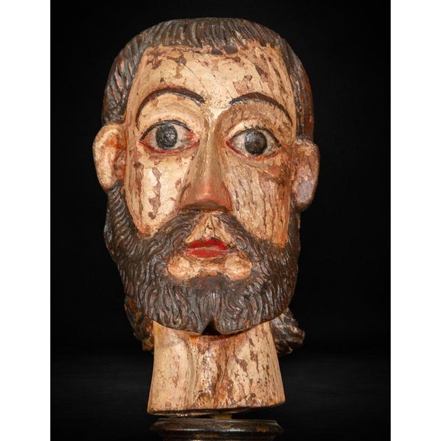 Expressive carved and polychromed wooden head of a male saint, produced in Colonial Mexico during the late 16th or early...