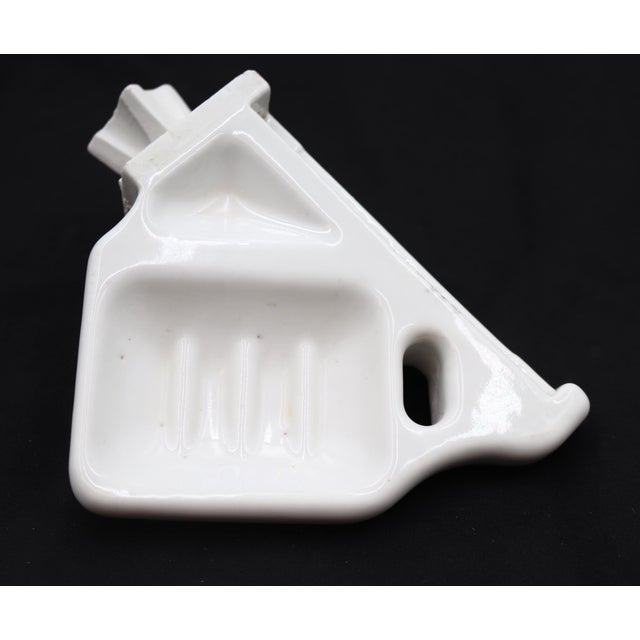Vintage corner soap and toothbrush holder made of white porcelain over ceramic. It has the capacity to hold soap and one...