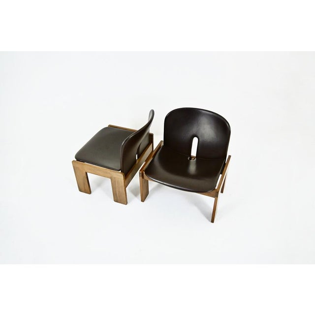 Set of 2 dark brown leather and wood chairs, designed by Afra & Tobia Scarpa. Model: 925. Marked "Cassina". Seat height:...