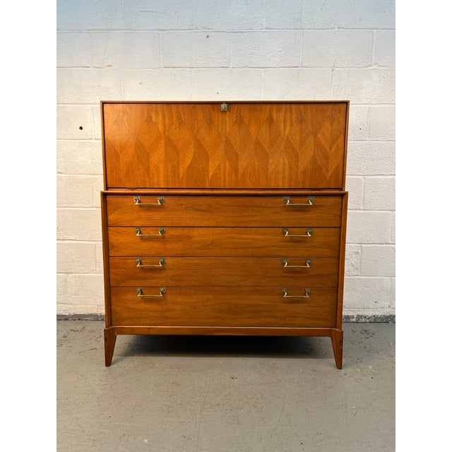 A striking example of American mid-century craftsmanship, this vintage highboy dresser by Red Lion Table Company showcases...
