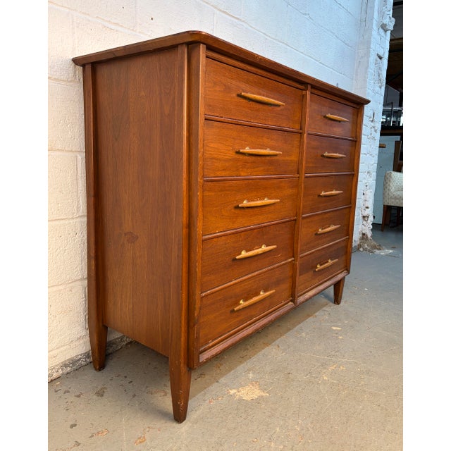 A stunning example of American mid-century craftsmanship, this ten-drawer walnut dresser by Davis Cabinet Company combines...