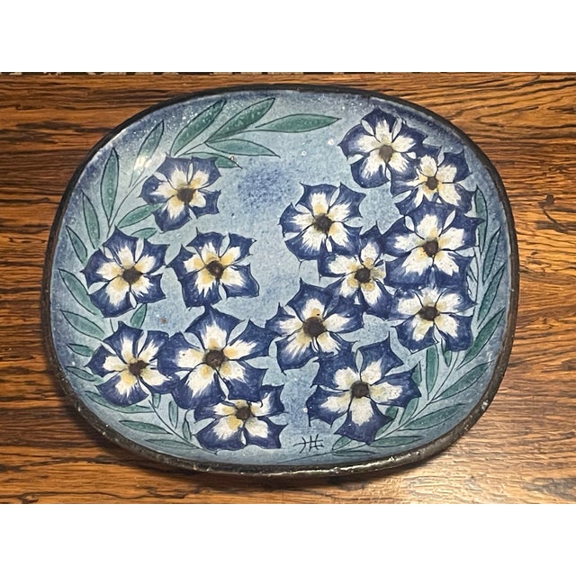 This is a Ken Edwards "El Palomar" Blue Floral Pottery Platter. The mark on the bottom identifies it as part of the "El...