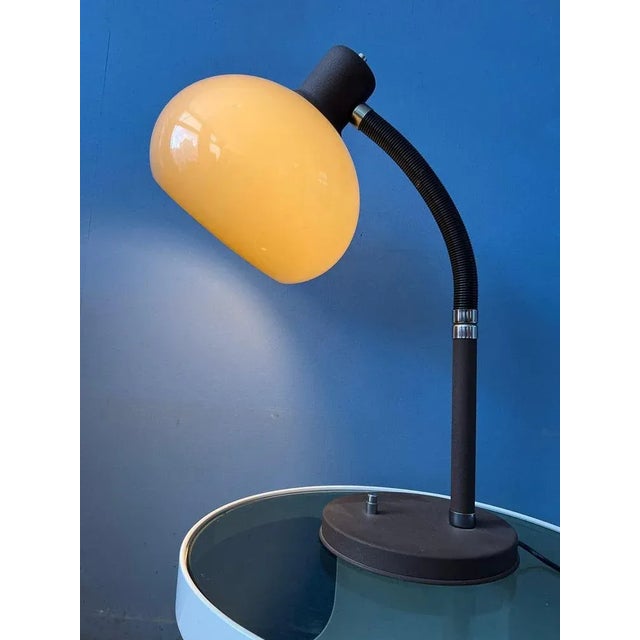 A very flexible mushroom table lamp by herda. The acryllic mushroom shade produces a warm light. This model has a...