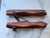 A pair of antique ice skates. Painted red wood and steel blades with leather straps. Nice for holiday decor.