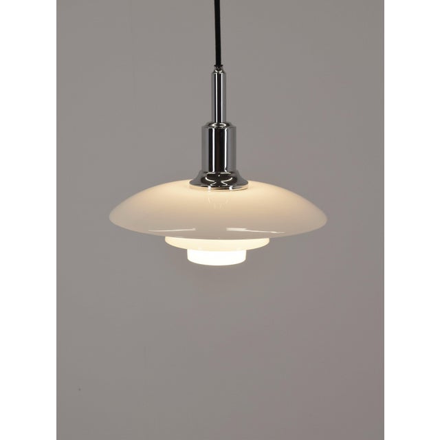 Danish pendant lamp ph 3/2 designed by poul henningsen. This iconic lamp was manufactured by the world-renowned...