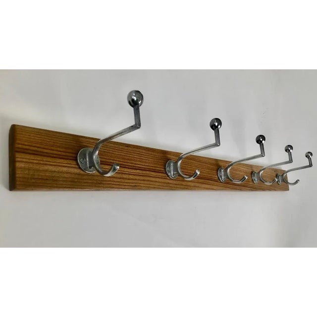 A beautiful set of five aluminium Bauhaus coat hooks . All five hooks are mounted to the original walnut back board. The...