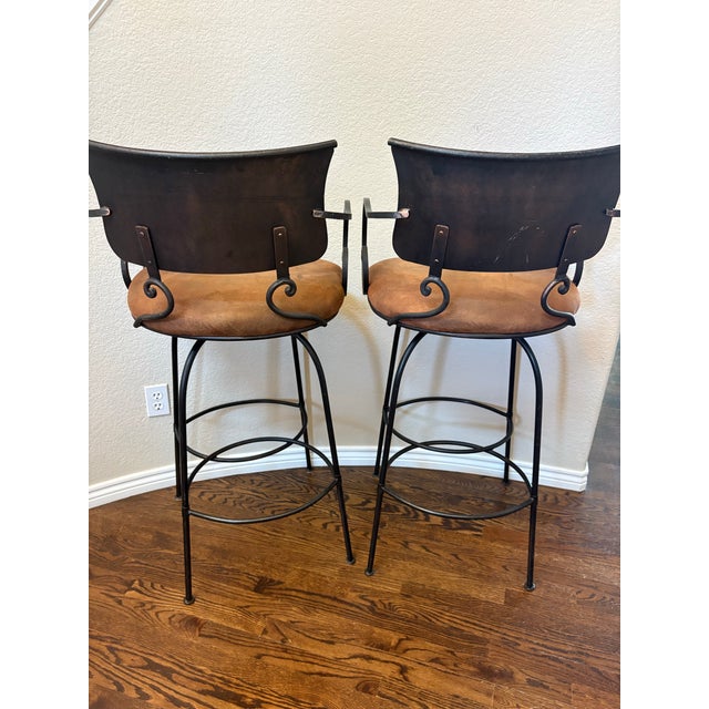 Bring timeless Old World elegance to your home with this exceptional pair of Arhaus Obra 32” Swivel Wrought Iron Bar...