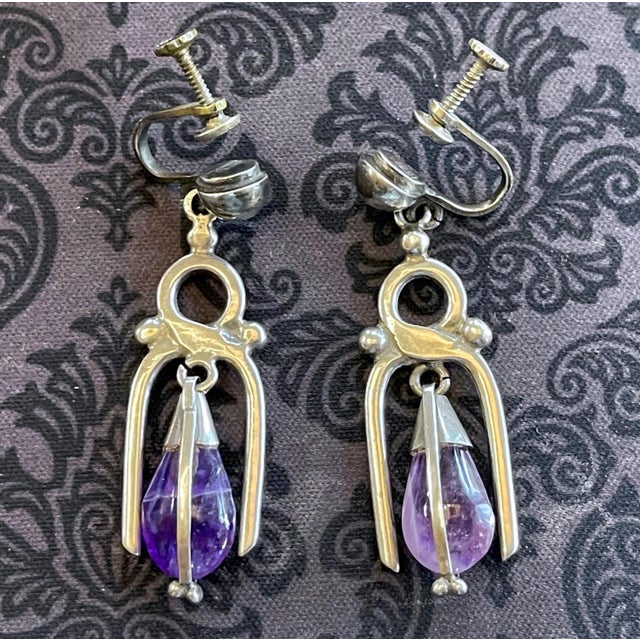 A pair of Mexican modern earrings in sterling silver with teardrop amethyst circa 1950-60s. The earrings are screwed on as...