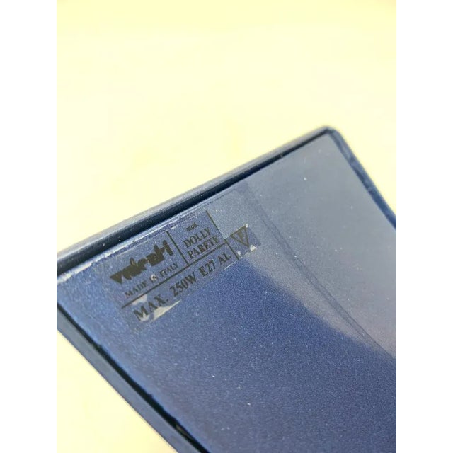 Wall lamp composed of a light purple satin glass diffuser with an inverted chalice shape, slightly flared towards the top....