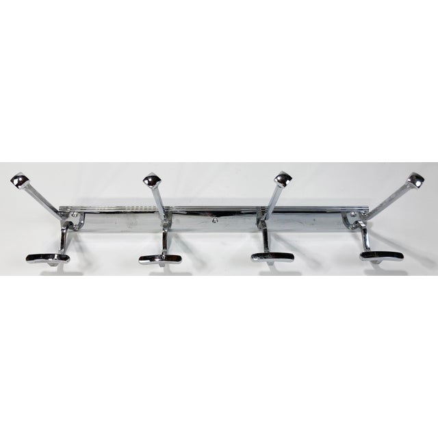 Vintage modern French chrome wall mount coat rack. Features eight (8) hooks for hanging. Ideal for hats and coats. Holes...