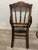 Elegant hand-woven cane chair featuring the hallmarks of late Victorian and Eastlake design, notably the geometric,...