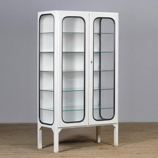 Vintage medical cabinet from the 1970s, made in Hungary. This characterful cabinet is made of iron and glass, with the...