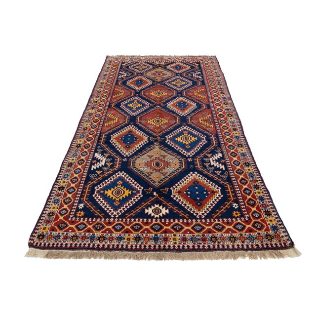 This Antique Shiraz hand-knotted wool rug has a multicolor-designed field with an allover pattern. This rug measures 5'2"...