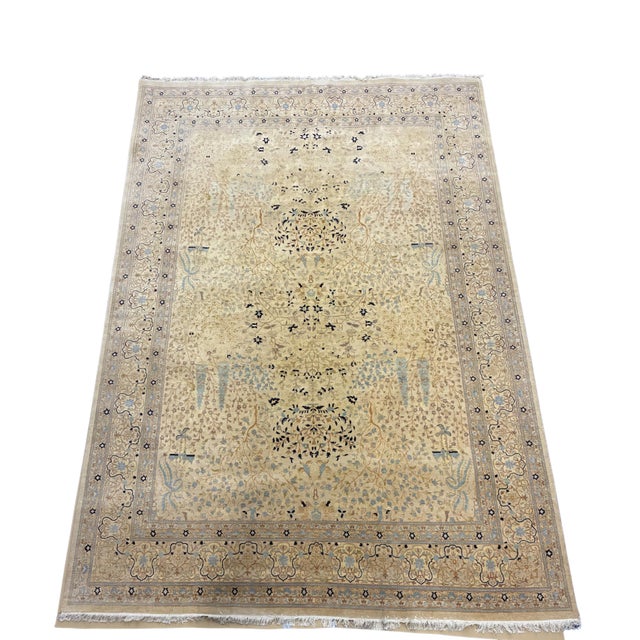Large hand-knotted wool area rug by Safavieh featuring an intricate Persian-inspired Tree of Life and garden design. The...